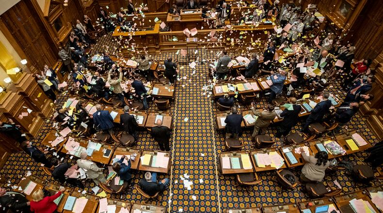 06/26/2020 - Atlanta, Georgia - Georgia Senators throw paper in the air as the legislative session comes to an end in the Senate Chambers on Sine Die, day 40, of the legislative session in Atlanta, Friday, June 26, 2020. (ALYSSA POINTER / ALYSSA.POINTER@AJC.COM)