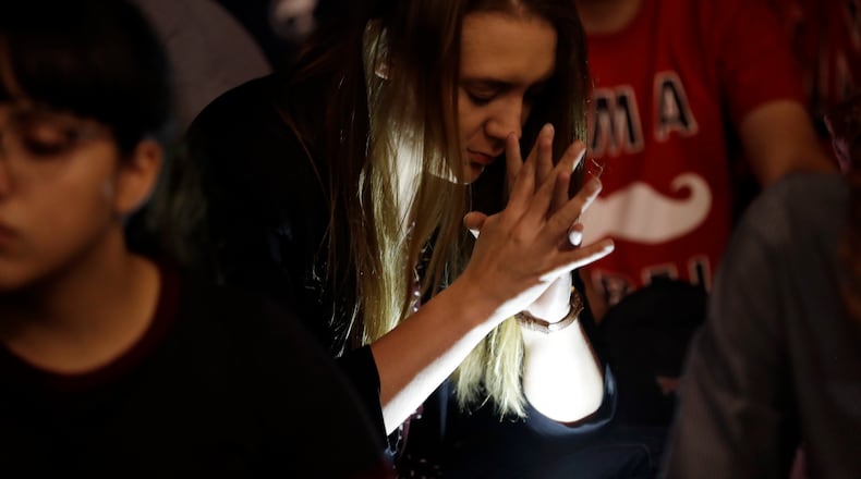 Students from University of Nevada Las Vegas hold a vigil Monday, Oct. 2, 2017, in Las Vegas. A gunman on the 32nd floor of the Mandalay Bay casino hotel rained automatic weapons fire down on the crowd of over 22,000 at an outdoor country music festival Sunday. (AP Photo/Gregory Bull)