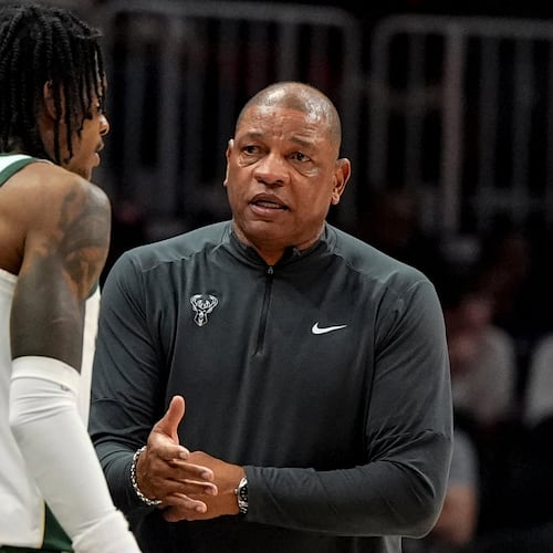 Milwaukee Bucks head coach Doc Rivers speaks to Kevin Porter Jr. (7) during the first half of an NBA basketball game against the Atlanta Hawks, Saturday, March 14, 2026, in Atlanta. (AP Photo/Mike Stewart)