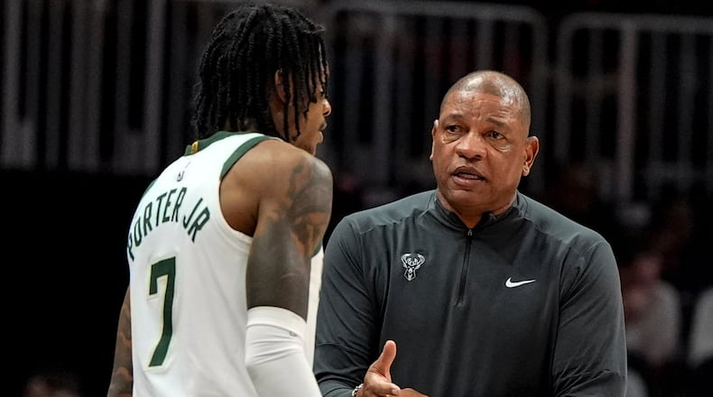 Milwaukee Bucks head coach Doc Rivers speaks to Kevin Porter Jr. (7) during the first half of an NBA basketball game against the Atlanta Hawks, Saturday, March 14, 2026, in Atlanta. (AP Photo/Mike Stewart)