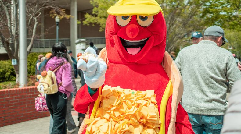 Sammy the Slaw Dog holds a hot dog covered in hot slaw at the Hot Slaw and Art Y'all festival in Cleveland, Tennessee. Courtesy of the Cleveland Chamber of Commerce