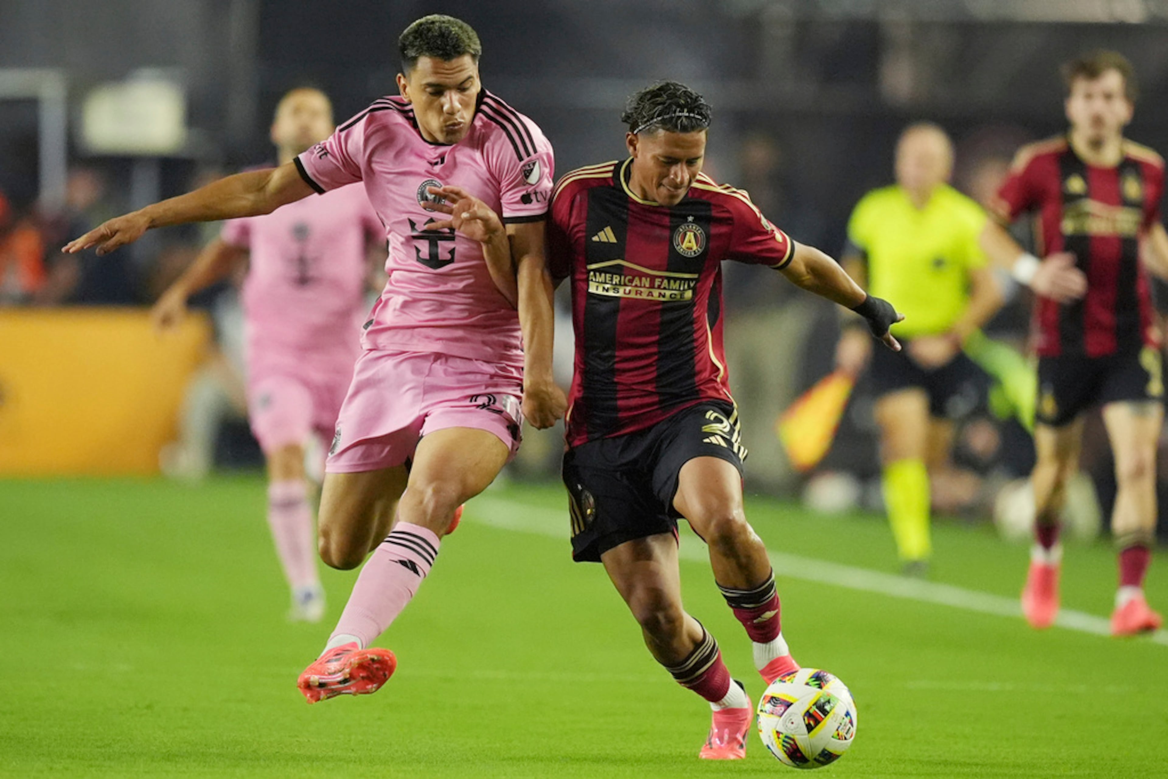 Inter Miami midfielder Diego Gómez (20) and Atlanta United defender Ronald Hernández (2) go after the ball during the first half of their MLS playoff opening round soccer match, Saturday, Nov. 9, 2024, in Fort Lauderdale, Fla. (Rebecca Blackwell/AP)