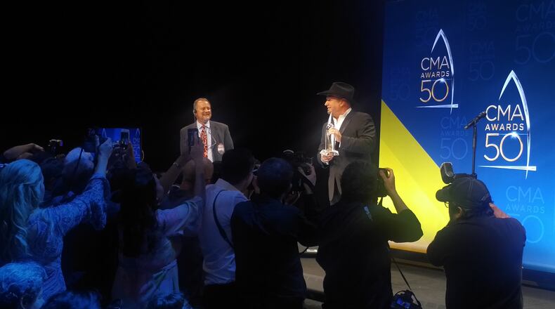 Garth Brooks posing for photographers in the press room at the CMA Awards. Photo: Melissa Ruggieri/AJC