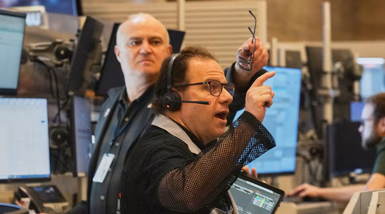 Options trader Anthony Spina, foreground, works on the floor of the New York Stock Exchange, Thursday, April 30, 2026. (AP Photo/Richard Drew)