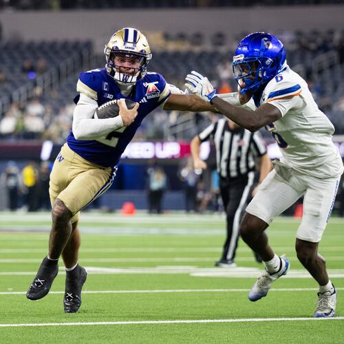 Washington quarterback Demond Williams Jr. (2) applies stiff arm to Boise State defensive back Jeremiah Earby (6) during the second half of the LA Bowl NCAA college football game Saturday, Dec. 13, 2025, in Inglewood, Calif. (AP Photo/Kyusung Gong)