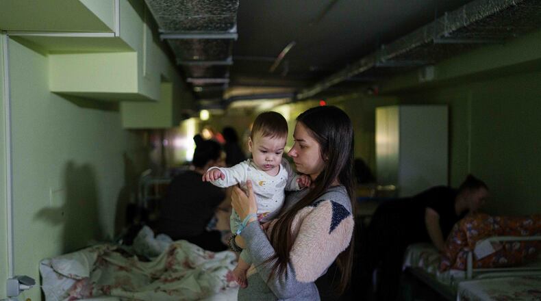 Marharyta Nekhoroshyva holds her son Mark inside a shelter at the children's regional hospital of Zaporizhzhia, Ukraine, on Thursday, May 7, 2026. (AP Photo/Evgeniy Maloletka)