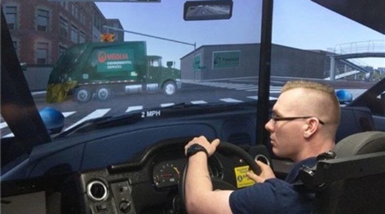 Snellville Police Officer Aaron Devries takes a turn on a decision-based public safety driver training simulator. Courtesy City of Snellville