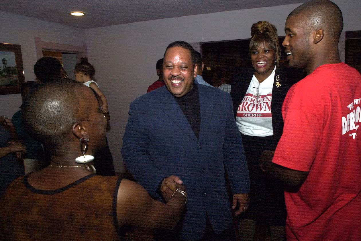DeKalb County Sheriff-elect Derwin Brown, pictured here with well-wishers at his election victory party in August 2000, was murdered two weeks before taking office on the orders of outgoing Sheriff Sidney Dorsey. (Kent D. Johnson/AJC)