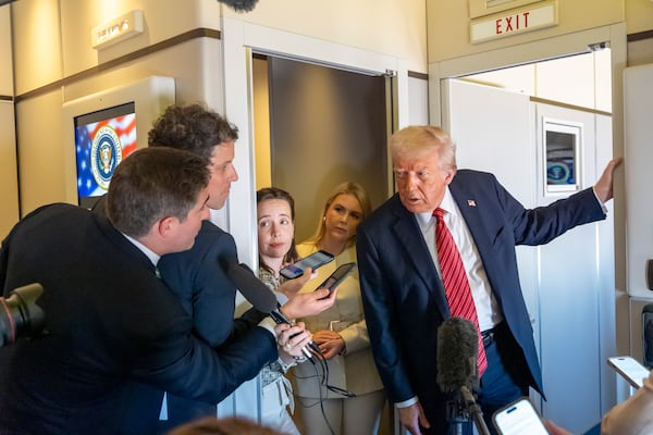 President Donald Trump speaks to reporters aboard Air Force One en route from Riyadh, Saudi Arabia to Doha, Qatar, Wednesday, May 14, 2025. (AP Photo/Alex Brandon)