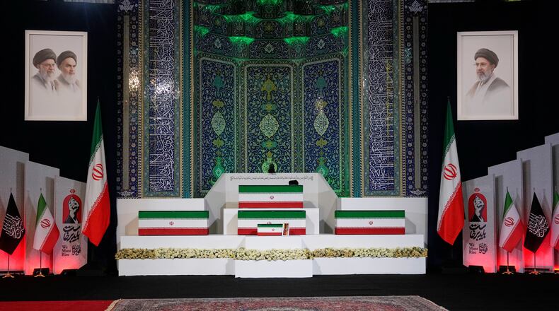 The coffins of slain Iranian Supreme Leader Ayatollah Ali Khamenei, center on top, and members of his family are displayed ahead of the dayslong funeral ceremonies at the Imam Khomeini Mosalla Grand Mosque in Tehran, Iran, Friday, July 3, 2026. (AP Photo/Vahid Salemi)