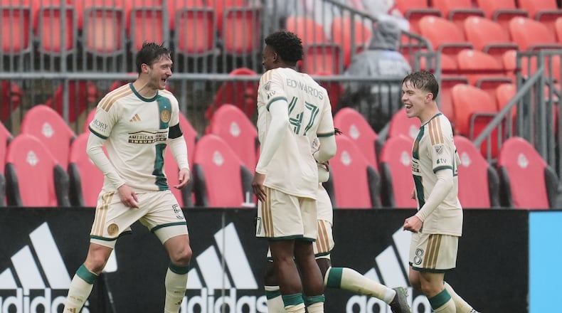 Atlanta United's Alexey Miranchuk (left) celebrates with teammates after scoring a goal against Toronto FC during the second half in Toronto on Saturday, April 25, 2026. (Frank Gunn/The Canadian Press via AP)