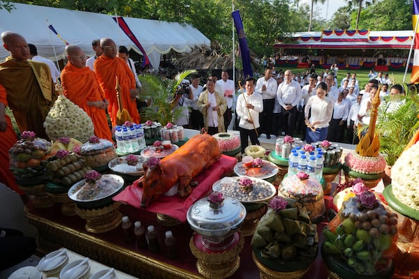 Cambodian town hall officers offer prayer at a ceremony during an annual of Remembrance Day at Choeung Ek, a former Khmer Rouge "killing field," on the outskirt of Phnom Penh, Cambodia Tuesday, May 20, 2025. (AP Photo/Heng Sinith)