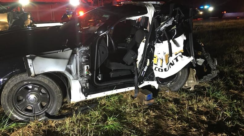 A Forsyth County Sheriff's Office deputy  was injured early Saturday when a vehicle driven by a suspected DUI driver crashed into his parked patrol car on Ga. 400.