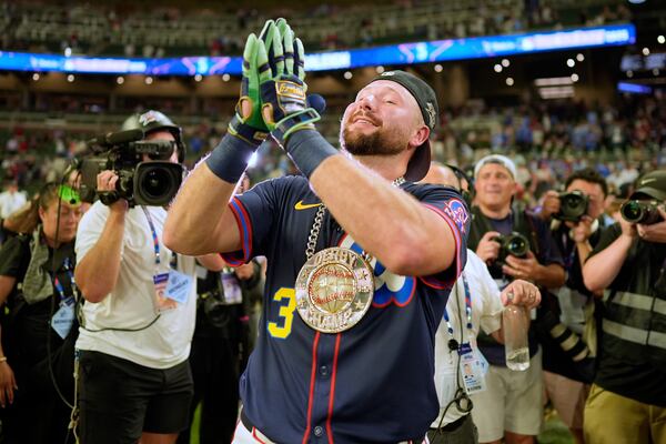 Seattle Mariners' Cal Raleigh celebrates after winning the MLB baseball All-Star Home Run Derby, Monday, July 14, 2025, in Atlanta. (AP Photo/Mike Stewart)