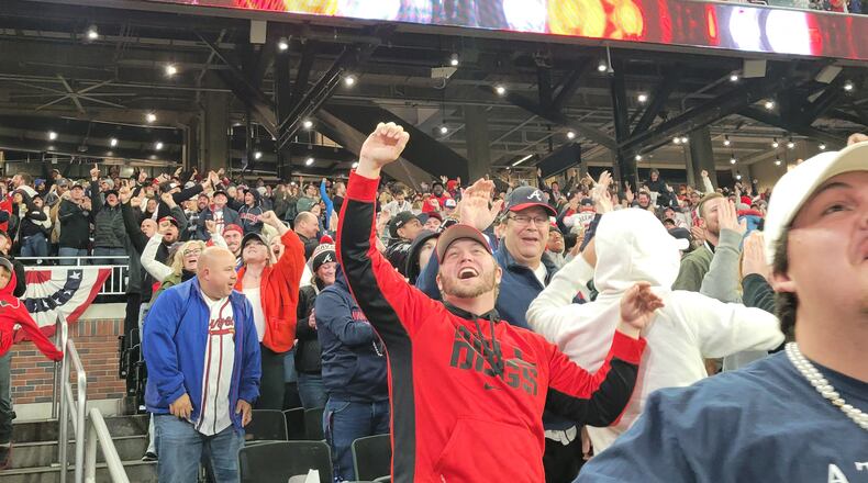 Braves fans in Truist Park celebrate after a triple home run by Jorge Soler in Houston. Fans gathered for a watch party at the Braves stadium for Game 6 of the World Series. (Sam Sinclair / Fresh TAke Georgia)