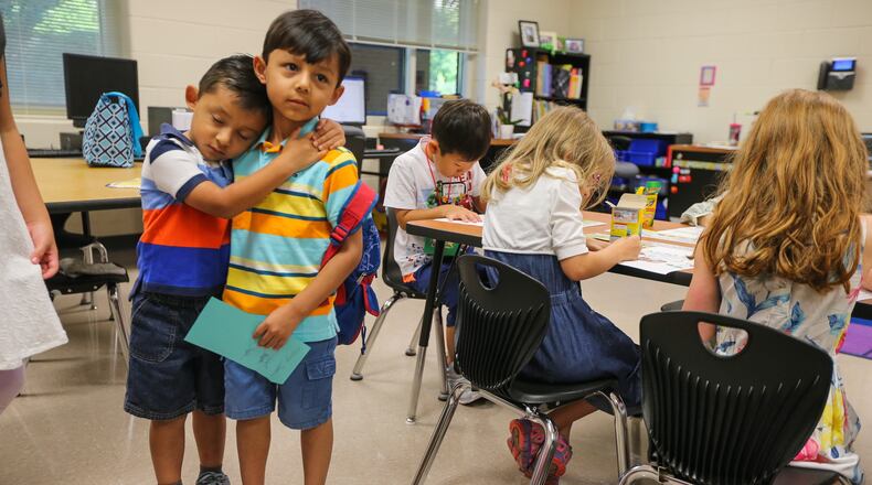 Jeremiah, 4, (left) says goodbye to big brother Jacob Cabarello, 6, before starting kindergarten at Mountain View elementary school in Cobb County on Monday, July 31, 2017.