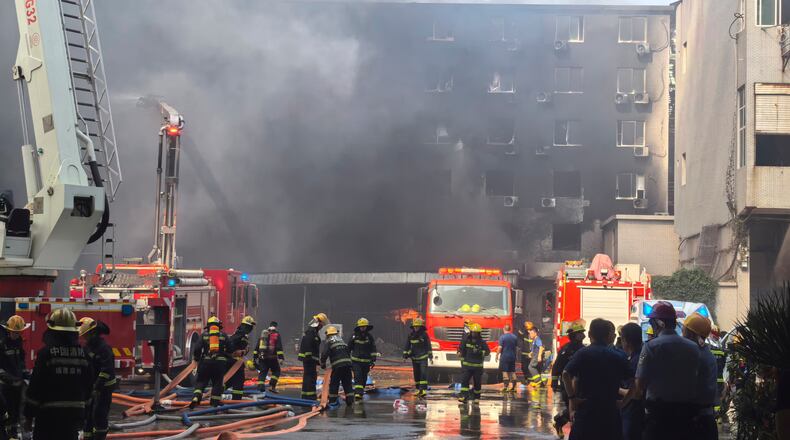 In this photo released by Xinhua News Agency, firefighters at the scene of a footwear factory fire in Jiangtou village, Chendai township of Jinjiang city, southeastern China's Fujian province, Thursday, July 9, 2026. (Zheng Liang/Xinhua via AP)