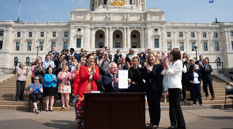 Gov. Tim Walz is seen at a ceremonial budget bill-signing party on the Minnesota State Capitol steps. (GLEN STUBBE/STAR TRIBUNE/GETTY IMAGES)