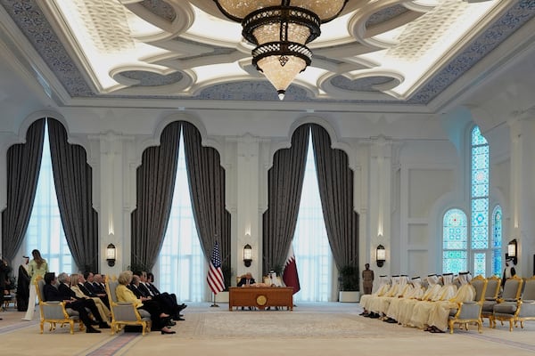 President Donald Trump and Qatar's Emir Sheikh Tamim bin Hamad Al Thani sign documents during a signing ceremony at the Amiri Diwan in Doha, Qatar, Wednesday, May 14, 2025. (AP Photo/Alex Brandon)