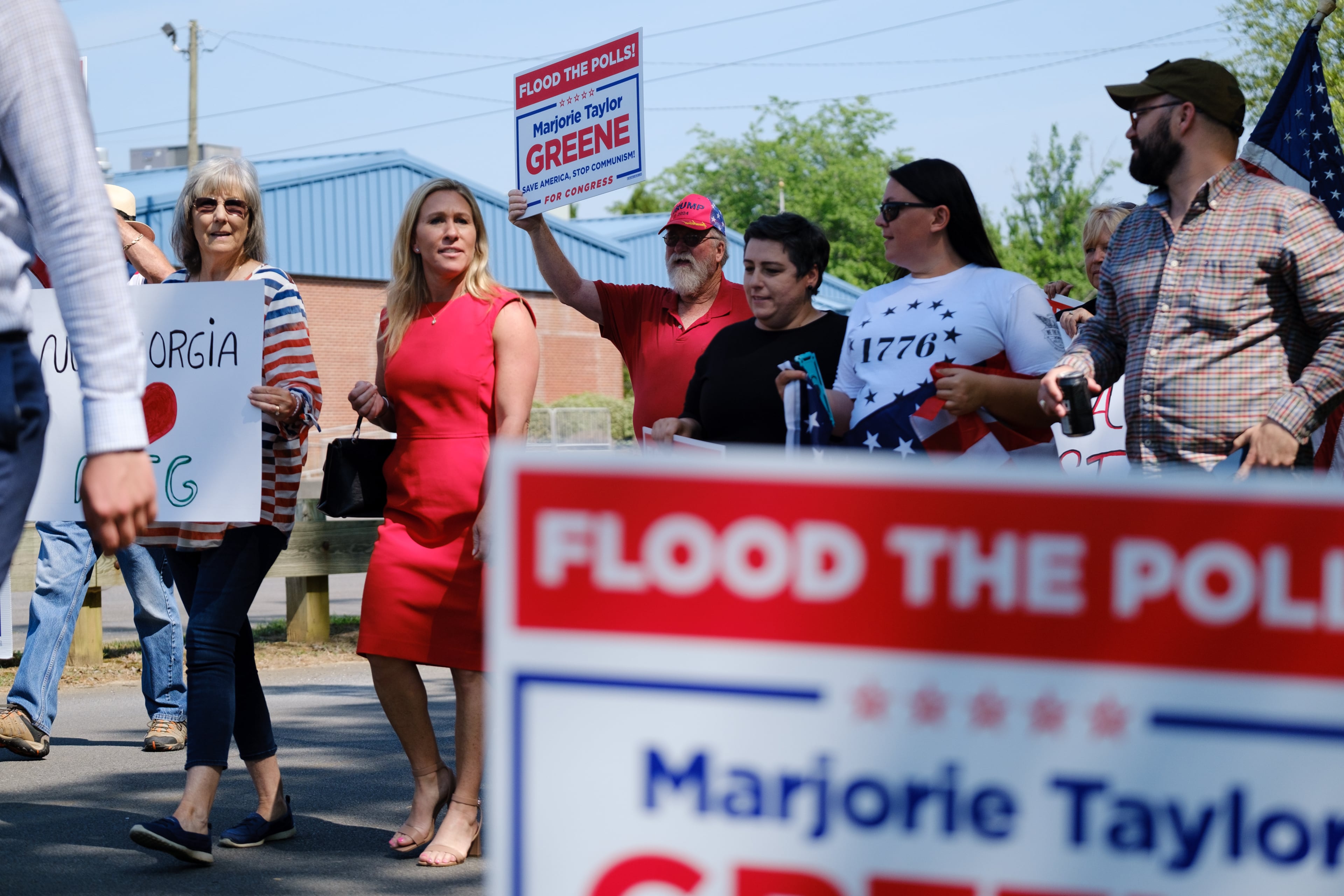 U.S. Rep. Marjorie Taylor Greene (red dress) campaigned for office in Rome in 2022. (Arvin Temkar/AJC)