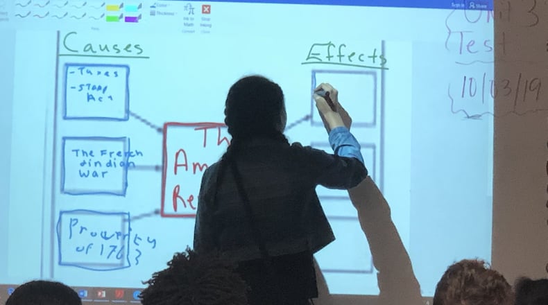 A Northbrook Middle School student takes part in a social studies lesson using an interactive whiteboard. Gwinnett County has invested about $40 million in technology upgrades for middle schools. ARLINDA SMITH BROADY/AJC