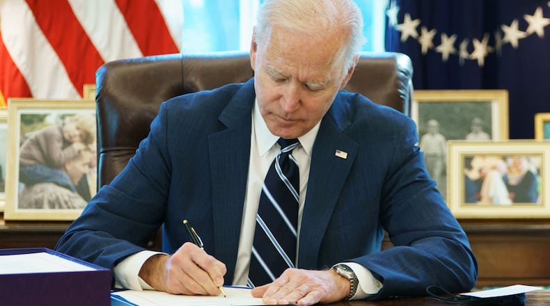 President Joe Biden signs the American Rescue Plan in the Oval Office. (Mandel Ngan/AFP/TNS)