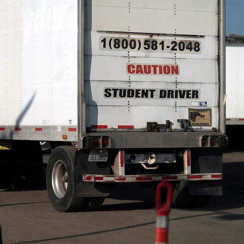 FILE - A student driver helps his classmate steer the wheel into the right direction as they practice driving in reverse in Calif., Nov. 17, 2021. (AP Photo/Jae C. Hong, File)