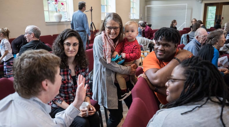 Kirsten Browning (from left), Michelle Caruso, Jaine Alexander, who is holding 14-month-old Henry, Kylan Pew and Mirissa Tucker talk in a group as part of a worship service at Neighborhood Church on Oct. 20, 2019, in Atlanta. Two churches — Druid Hills United Methodist Church and Epworth United Methodist Church — merged to form the new church. BRANDEN CAMP / SPECIAL
