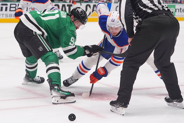 Dallas Stars center Tyler Seguin (91) and Edmonton Oilers center Mattias Janmark (13) face-off for the puck during the second period in Game 1 of the Western Conference finals in the NHL hockey Stanley Cup playoffs Wednesday, May 21, 2025, in Dallas. (AP Photo/LM Otero)