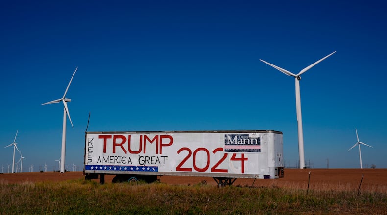 FILE - A trailer with a sign supporting President Donald Trump stands adjacent to the Smoky Hills wind farm, Sept. 30, 2024, near Ellsworth, Kan. (AP Photo/Charlie Riedel, file)