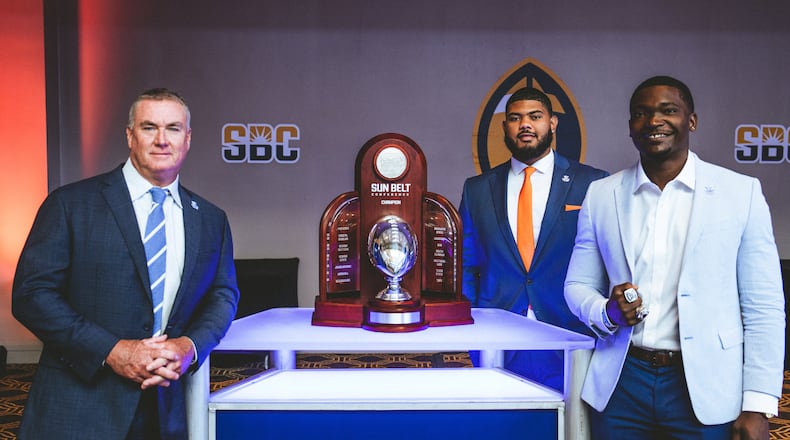Georgia State coach Shawn Elliott (L-R), Malik Sumter and Blake Carroll with the Sun Belt Championship trophy at the recent media days event. The Panthers want full-time possession of the trophy in 2022.