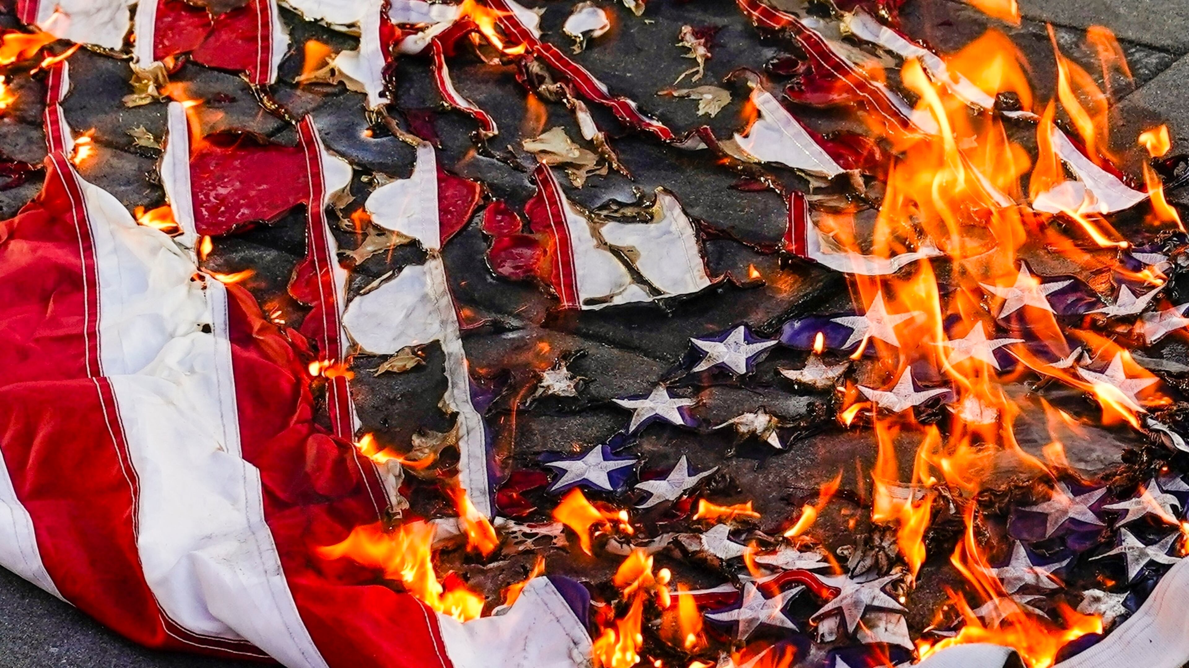 FILE - An American flag is burned during a march for Jayland Walker, July 6, 2022, in New York. (AP Photo/Frank Franklin II, File)