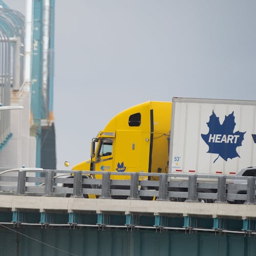 Transport trucks cross the Ambassador Bridge into the United States of America, in Windsor, Ontario, Canada, Saturday, Aug. 22, 2026. (Dax Melmer/The Canadian Press via AP)