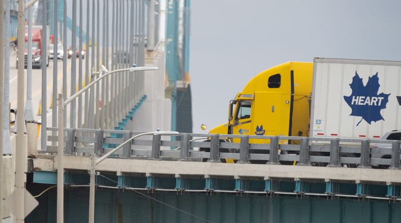 Transport trucks cross the Ambassador Bridge into the United States of America, in Windsor, Ontario, Canada, Saturday, Aug. 22, 2026. (Dax Melmer/The Canadian Press via AP)
