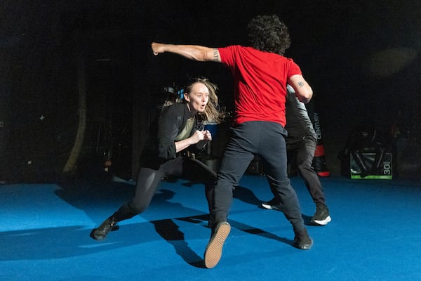 Stunt actors Jess Durham, left, and Brandon Martinez rehearse a fight scene. (Jason Getz/AJC)