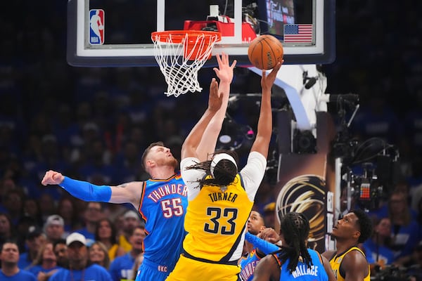 Indiana Pacers center Myles Turner (33) shoots against Oklahoma City Thunder center Isaiah Hartenstein (55) during the first half of Game 2 of the NBA Finals basketball series Sunday, June 8, 2025, in Oklahoma City. (AP Photo/Julio Cortez)