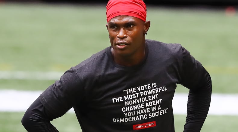 Falcons wide receiver Julio Jones wears a shirt in honor of late Georgia Congressman and civil-right leader John Lewis while preparing to play the Seattle Seahawks in the season opener Sunday, Sept. 13, 2020, in Atlanta. The shirt was the effort by the Falcons and a player-led social justice committee on their RISE UP & Vote initiative. (Curtis Compton / Curtis.Compton@ajc.com)
