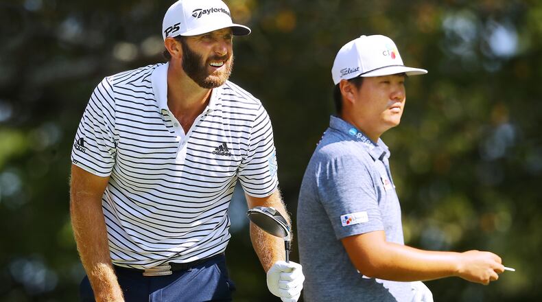 Early leader Dustin Johnson watches his drive off the fifth tee while Sungjae Im prepares to tee off during their third round of the Tour Championship Sunday, Sept. 6, 2020, at East Lake Golf Club in Atlanta.