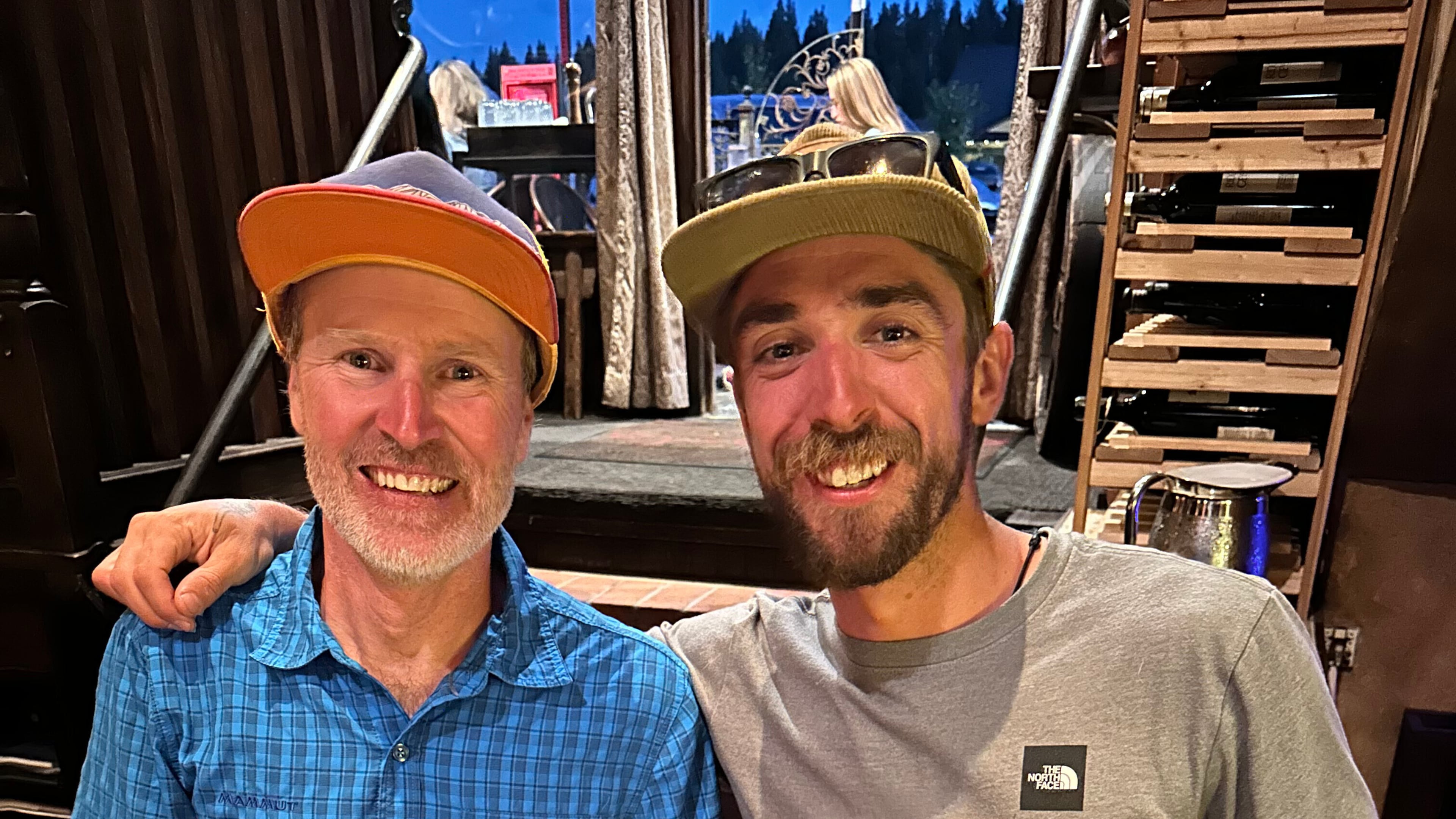 Michelino Sunseri, right, accepts a ceremonial belt buckle from Andy Anderson on Sept. 6, 2024, in Truckee, Calif., after breaking Anderson's record time for running up and down Grand Teton mountain in Grand Teton National Park in Wyoming a few days earlier. (Michelino Sunseri via AP)