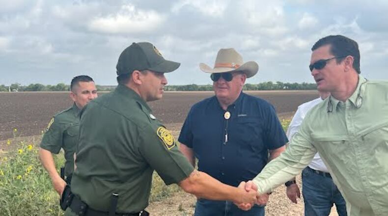 U.S. Rep. Austin Scott, R-Tifton, shakes hands with a U.S. Customs and Border Patrol agent while Agriculture Committee Chairman Glenn Thompson looks on during a visit to the Texas border with Mexico. Photo courtesy of Rep. Scott, U.S. House of Representatives.