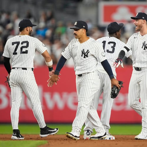 New York Yankees right fielder Spencer Jones, left fielder Cody Bellinger, and center fielder Trent Grisham, right to left, celebrate with teammates after winning a baseball game against the Boston Red Sox, Friday, Aug. 28, 2026, in New York. (AP Photo/Yuki Iwamura)