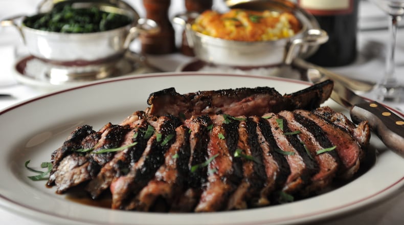 Bone-in ribeye (34oz) for two, corn pudding and sauteed spinach at Bone's. (Beckysteinphotography.com)
