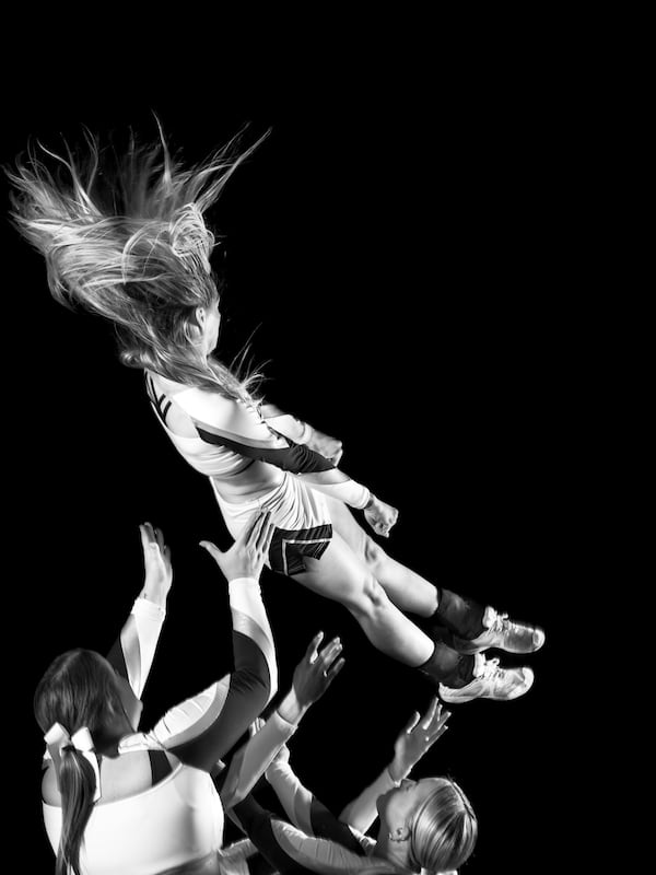 Brenau cheerleaders prepare to catch a teammate who has been tossed in the air. (Courtesy of Jill Frank)