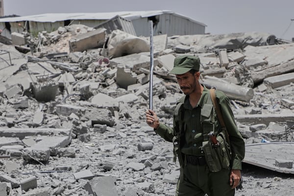A Yemeni soldier inspects the damage reportedly caused by U.S. airstrikes in Sanaa, Yemen, Sunday, April 27, 2025. (AP Photo/Osamah Abdulrahman)