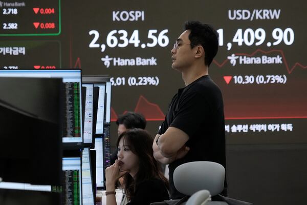 Currency traders watch monitors near a screen showing the Korea Composite Stock Price Index (KOSPI) and the foreign exchange rate between U.S. dollar and South Korean won, top right, at the foreign exchange dealing room of the KEB Hana Bank headquarters in Seoul, South Korea, Thursday, May 15, 2025. (AP Photo/Ahn Young-joon)