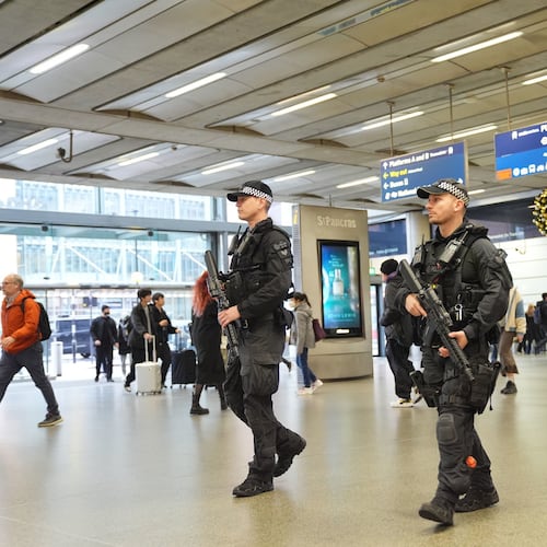 Armed police officers go on patrol at St Pancras International train station in London, England, Monday, Nov. 3, 2025. (Yui Mok/PA via AP)