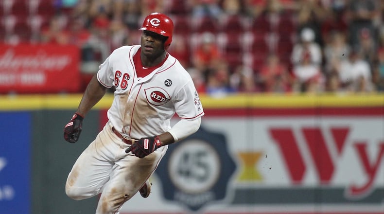 The Reds’ Yasiel Puig rounds the bases on his way to scoring the winning run in the 11th inning against the Brewers on Tuesday, July 2, 2019, at Great American Ball Park in Cincinnati. David Jablonski/Staff