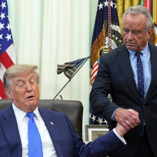 President Donald Trump, left, shakes the hand of Health and Human Services Secretary Robert F. Kennedy Jr. during a meeting to sign an executive order about vaccines, Monday, Aug. 10, 2026, in the Oval Office of the White House in Washington. (AP Photo/Jacquelyn Martin)