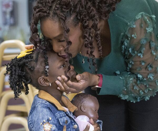 FILE - Zaneta Billyzone-Jatta kisses her two-year-old daughter Zakiah Jatta in her classroom at Akin's Early Learning Center in Auburn, Wash., March 26, 2024. (Ellen M. Banner/The Seattle Times via AP, File)