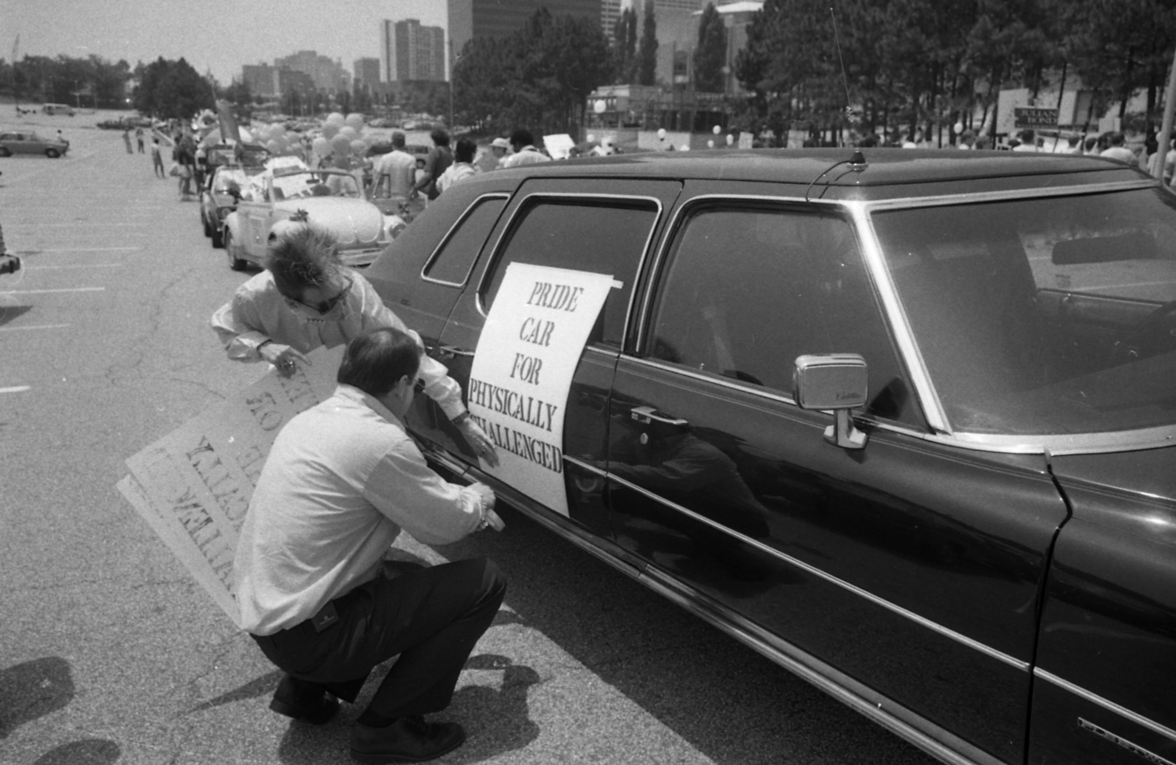 Putting signs on "Pride car for physically challenged," in the 17th annual Gay Pride Parade, Atlanta, June 21, 1986. (Atlanta Journal-Constitution Photographic Archives. Special Collections and Archives, Georgia State University Library.)